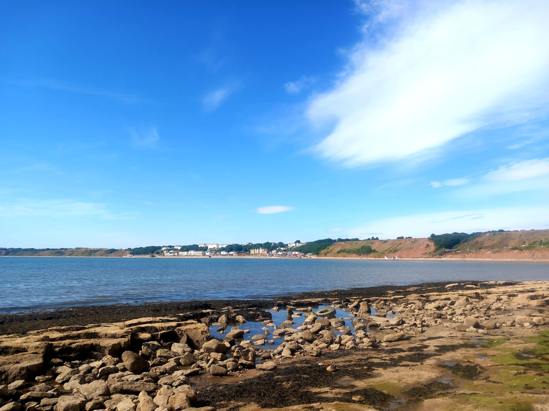 Filey town and beach seen from Filey Brigg on a bright day